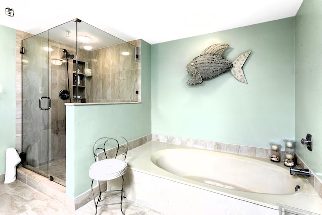 bathroom featuring separate shower and tub