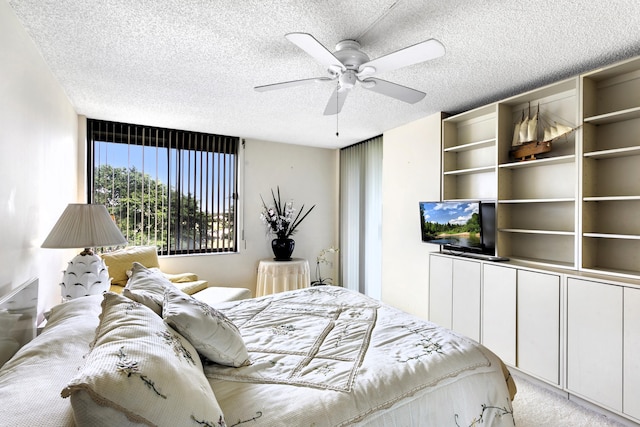 carpeted bedroom with a textured ceiling and ceiling fan