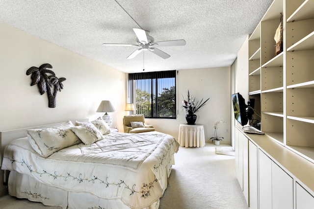 carpeted bedroom with a textured ceiling and ceiling fan