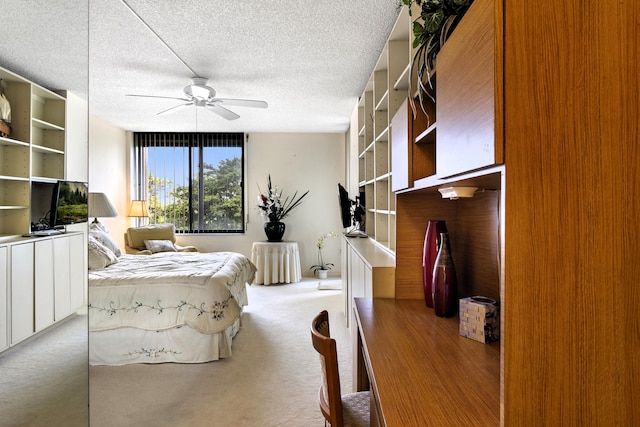 bedroom with light carpet, ceiling fan, and a textured ceiling