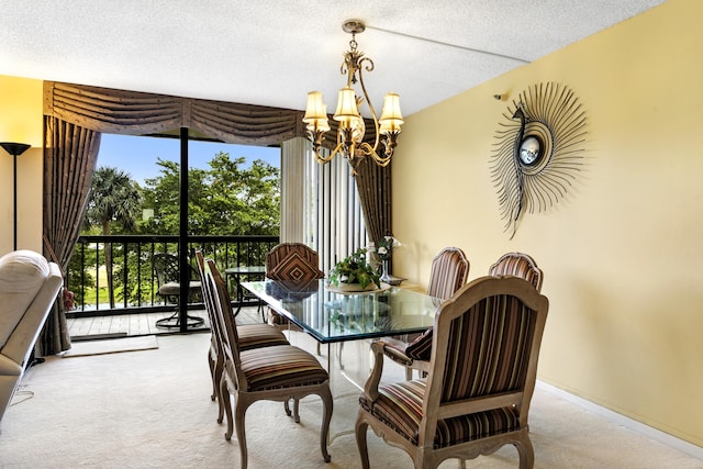 dining area featuring a textured ceiling, a notable chandelier, and light carpet