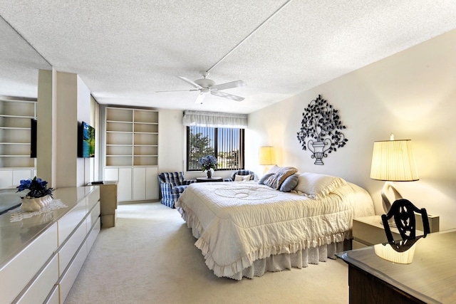 carpeted bedroom with a textured ceiling and ceiling fan