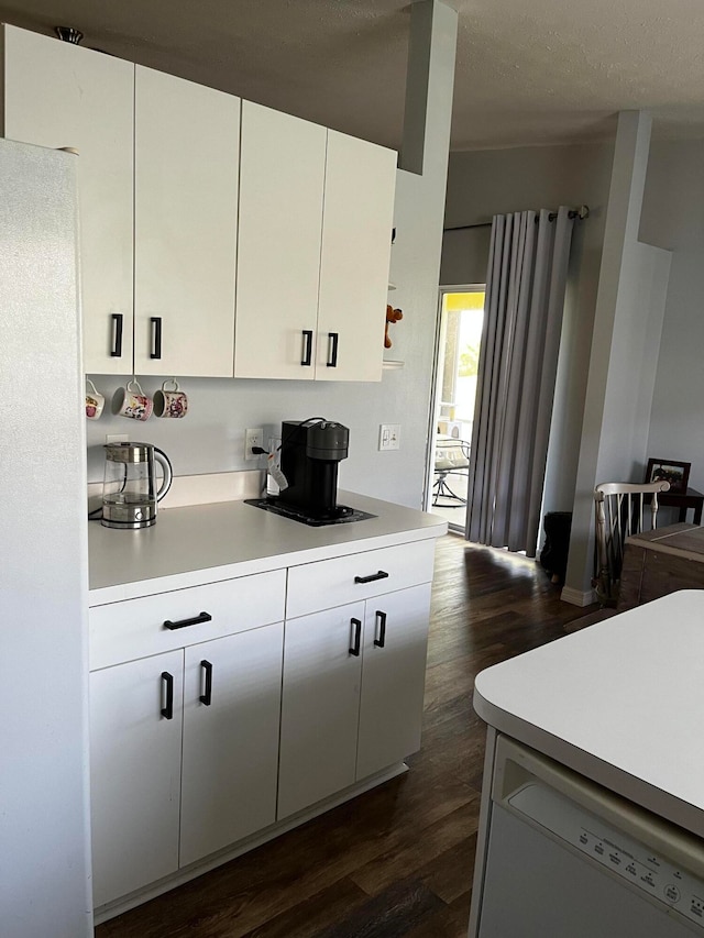 kitchen featuring refrigerator, a textured ceiling, white dishwasher, white cabinets, and dark hardwood / wood-style floors