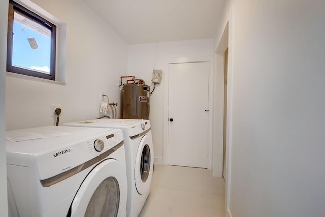 laundry area with electric water heater and separate washer and dryer