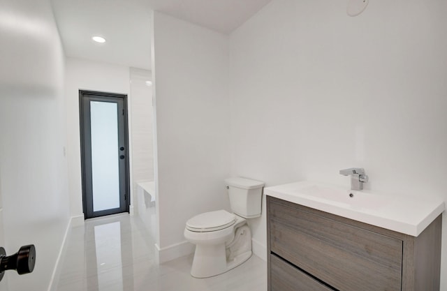 bathroom featuring tile patterned floors, vanity, and toilet