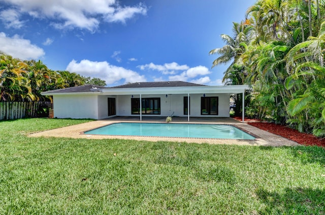 back of house with a lawn, a fenced in pool, and a patio