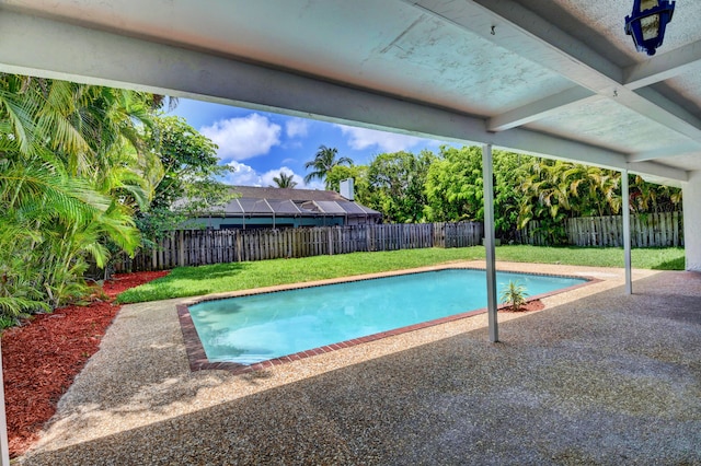 view of swimming pool featuring a lawn and a patio