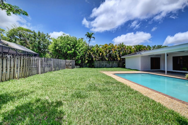 view of pool with a lawn and a patio area