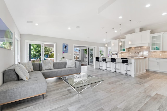 living room with light wood-type flooring and french doors