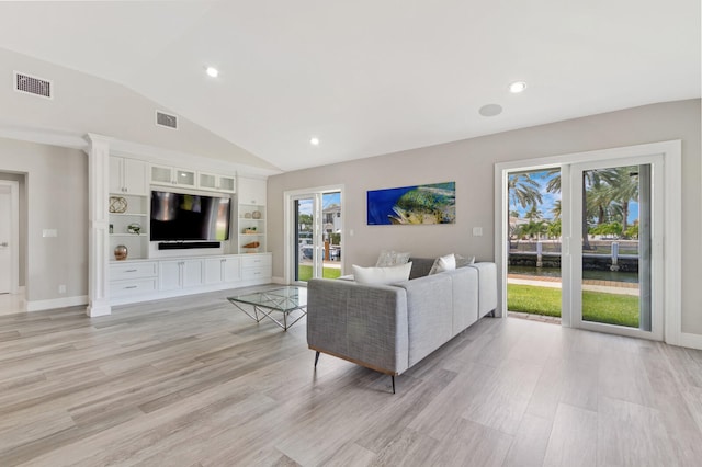 living room with vaulted ceiling and light hardwood / wood-style floors