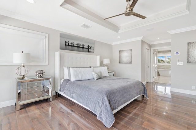 bedroom with a tray ceiling, ensuite bath, ceiling fan, and dark hardwood / wood-style floors