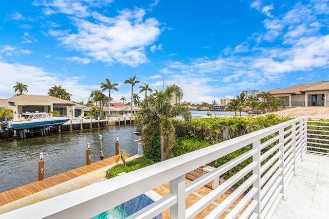 balcony with a dock and a water view