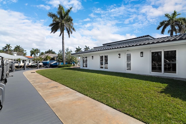 view of front of house featuring a front lawn and a patio