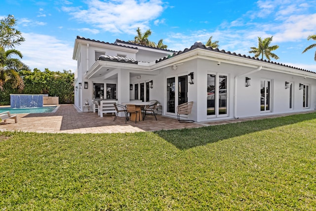 back of house with french doors, a yard, and a patio area