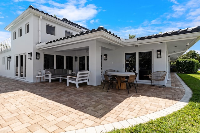 back of property featuring an outdoor living space, french doors, and a patio