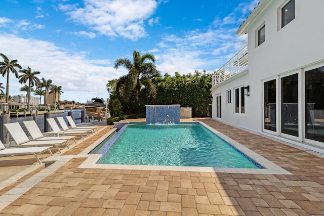 view of swimming pool with a patio area and pool water feature