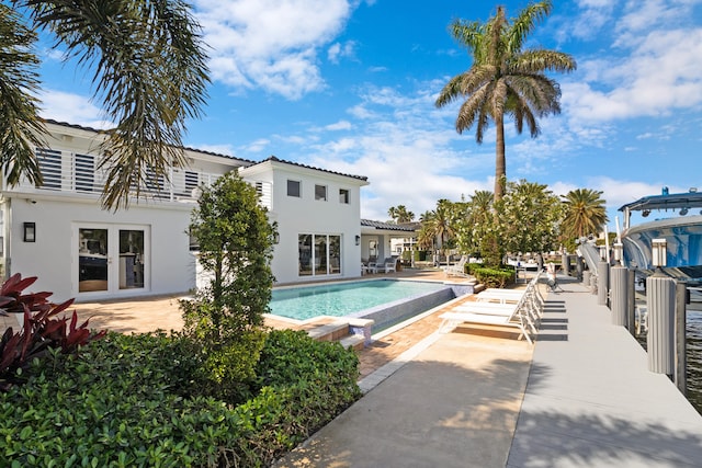 view of pool featuring a patio and french doors