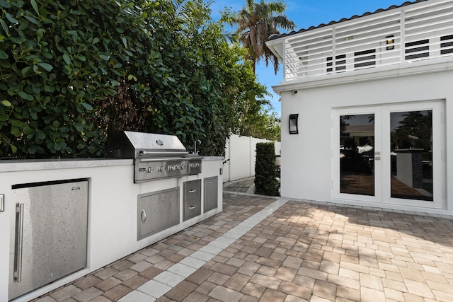 view of terrace with area for grilling and french doors