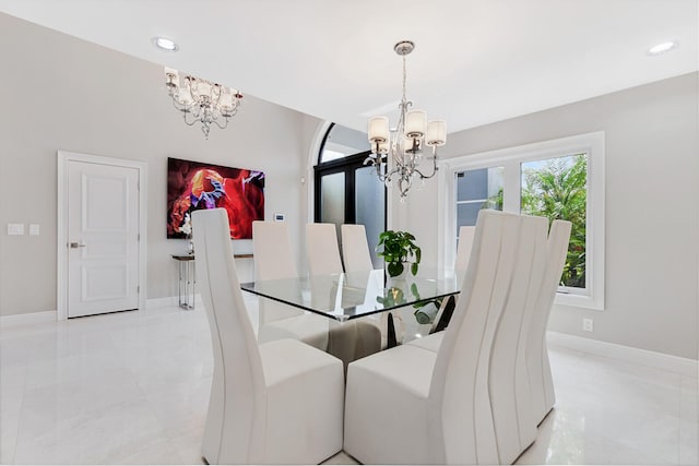 dining area with an inviting chandelier and light tile flooring