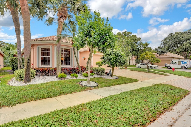 mediterranean / spanish-style home featuring a front yard