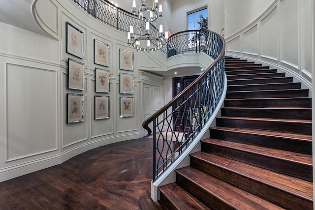 stairs with a high ceiling and an inviting chandelier