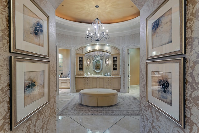 bathroom with vanity, a raised ceiling, and a notable chandelier