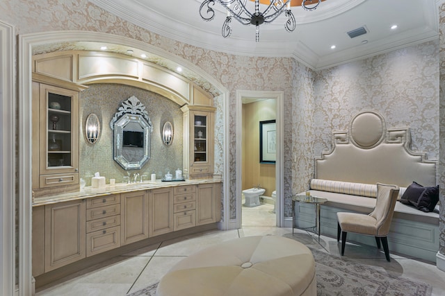 bathroom featuring tile patterned floors, crown molding, a bidet, toilet, and vanity