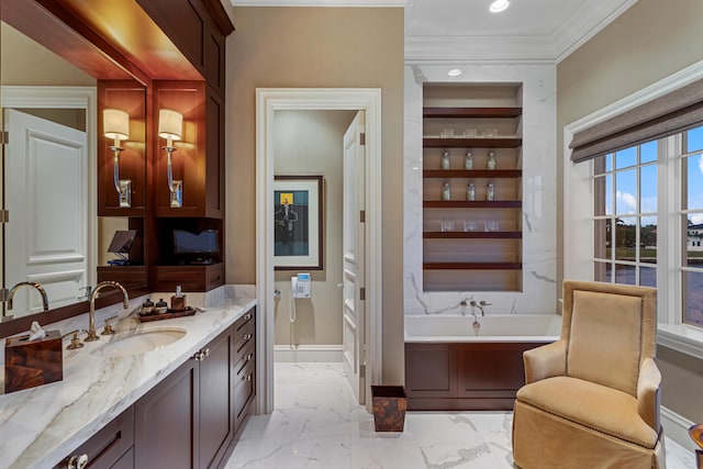 bathroom with vanity, ornamental molding, and a bathtub