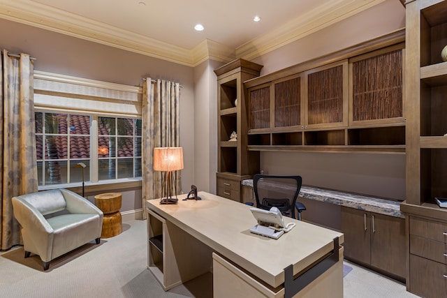 carpeted home office featuring ornamental molding and built in desk