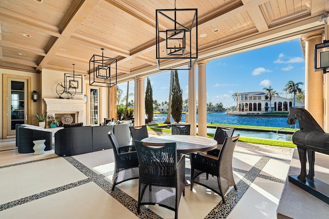 view of patio / terrace featuring an outdoor living space with a fireplace and a water view