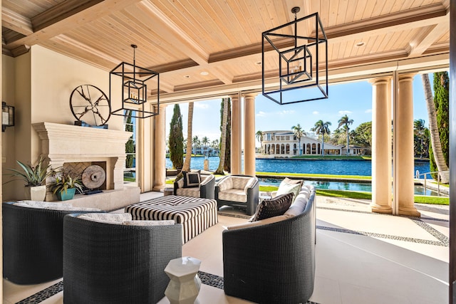 view of patio featuring a water view and a tiled fireplace