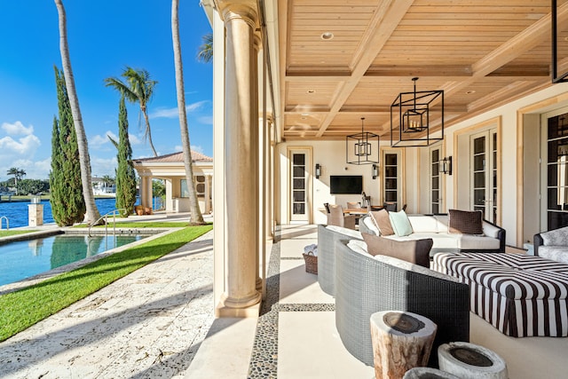 view of patio with an outdoor living space and a water view