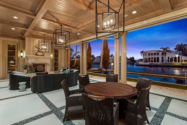 dining area featuring coffered ceiling, wood ceiling, a water view, beamed ceiling, and a fireplace