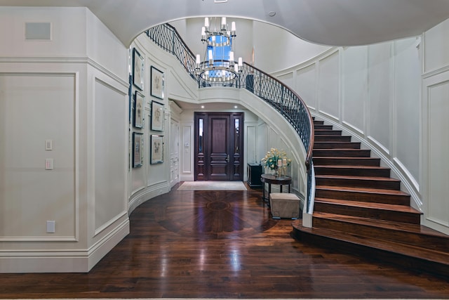 entryway featuring hardwood / wood-style flooring and an inviting chandelier