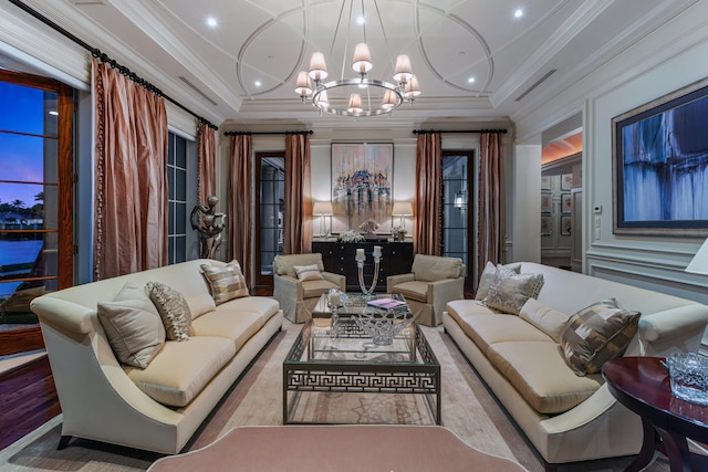 living room featuring ornamental molding, a chandelier, and light hardwood / wood-style floors