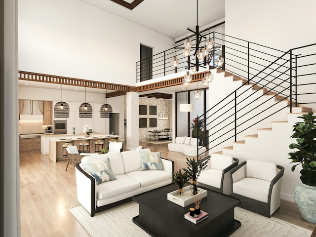 living room with light hardwood / wood-style floors and a high ceiling