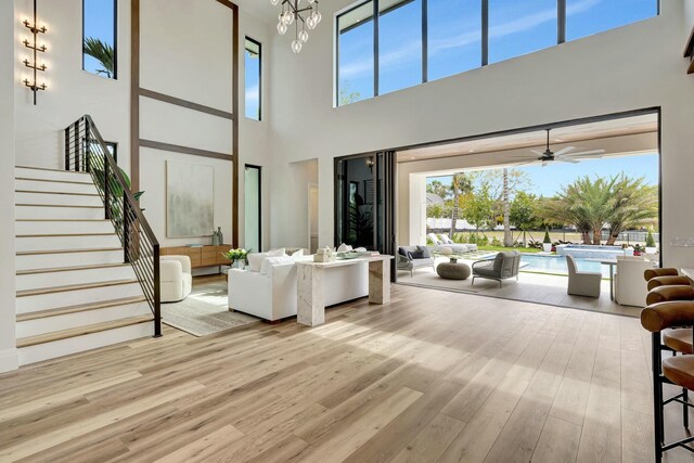 bedroom featuring access to outside, light hardwood / wood-style flooring, and beamed ceiling