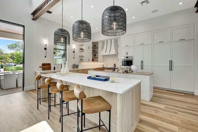 interior space with wood ceiling, ceiling fan, and sink