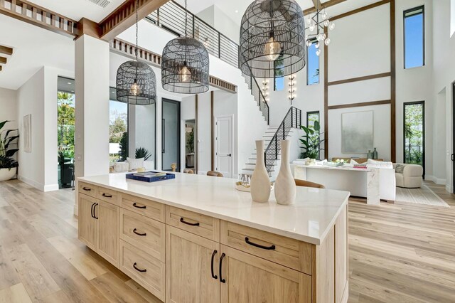 kitchen with custom exhaust hood, white cabinets, sink, tasteful backsplash, and kitchen peninsula