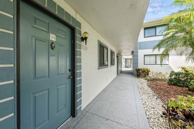 entrance to property with stucco siding