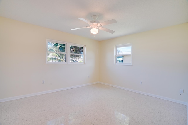 unfurnished room featuring a wealth of natural light and ceiling fan