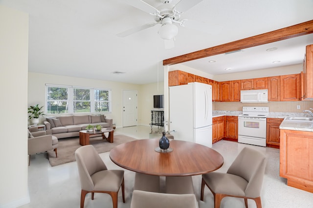 dining room with beam ceiling, ceiling fan, and sink