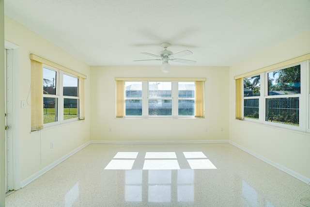 unfurnished room featuring ceiling fan and a textured ceiling