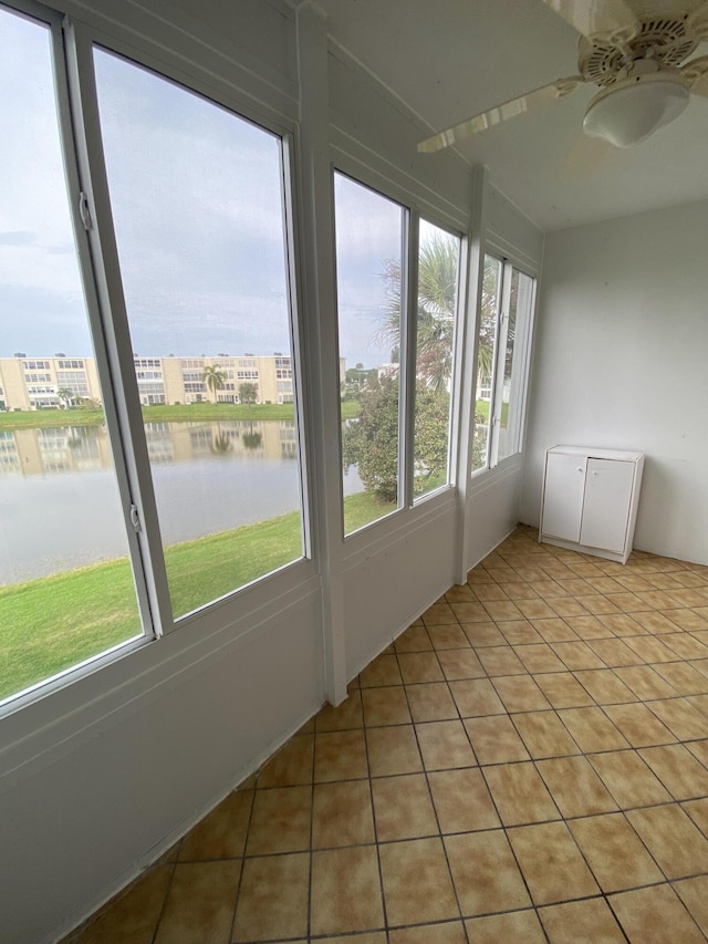 unfurnished sunroom featuring a water view