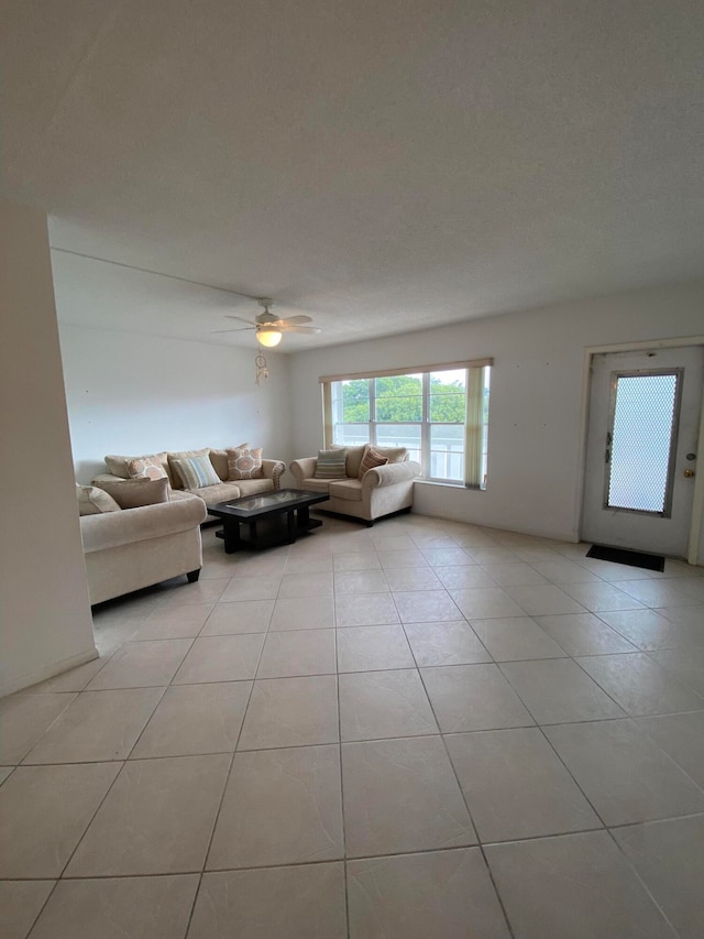 unfurnished living room with light tile patterned flooring and ceiling fan