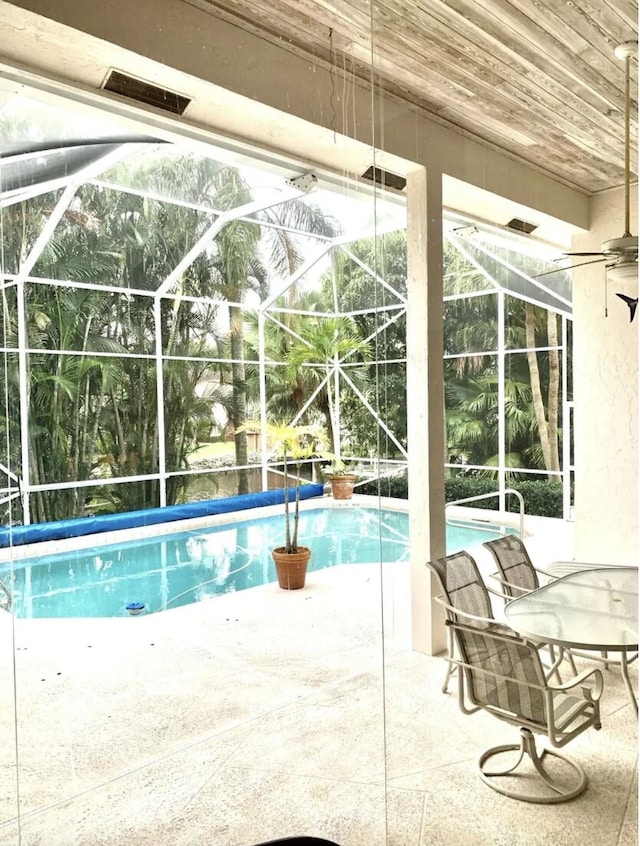 view of pool with a patio and a lanai