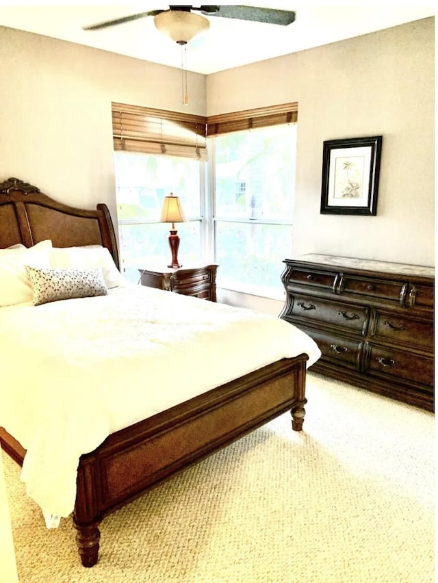 carpeted bedroom featuring ceiling fan