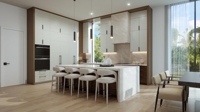 kitchen with backsplash, white cabinetry, wall chimney range hood, and light wood-type flooring