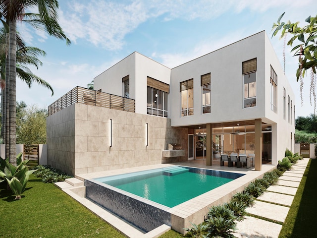 rear view of house featuring a fenced in pool, a patio area, and a balcony