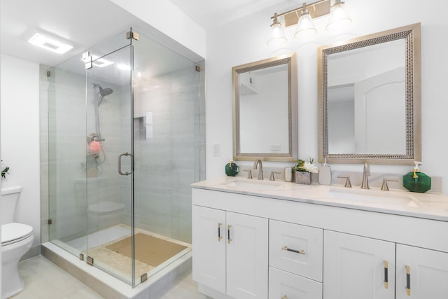 bathroom featuring toilet, tile flooring, large vanity, walk in shower, and double sink